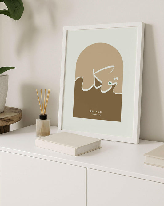 Framed artwork with Arabic calligraphy on a white surface with decor items.