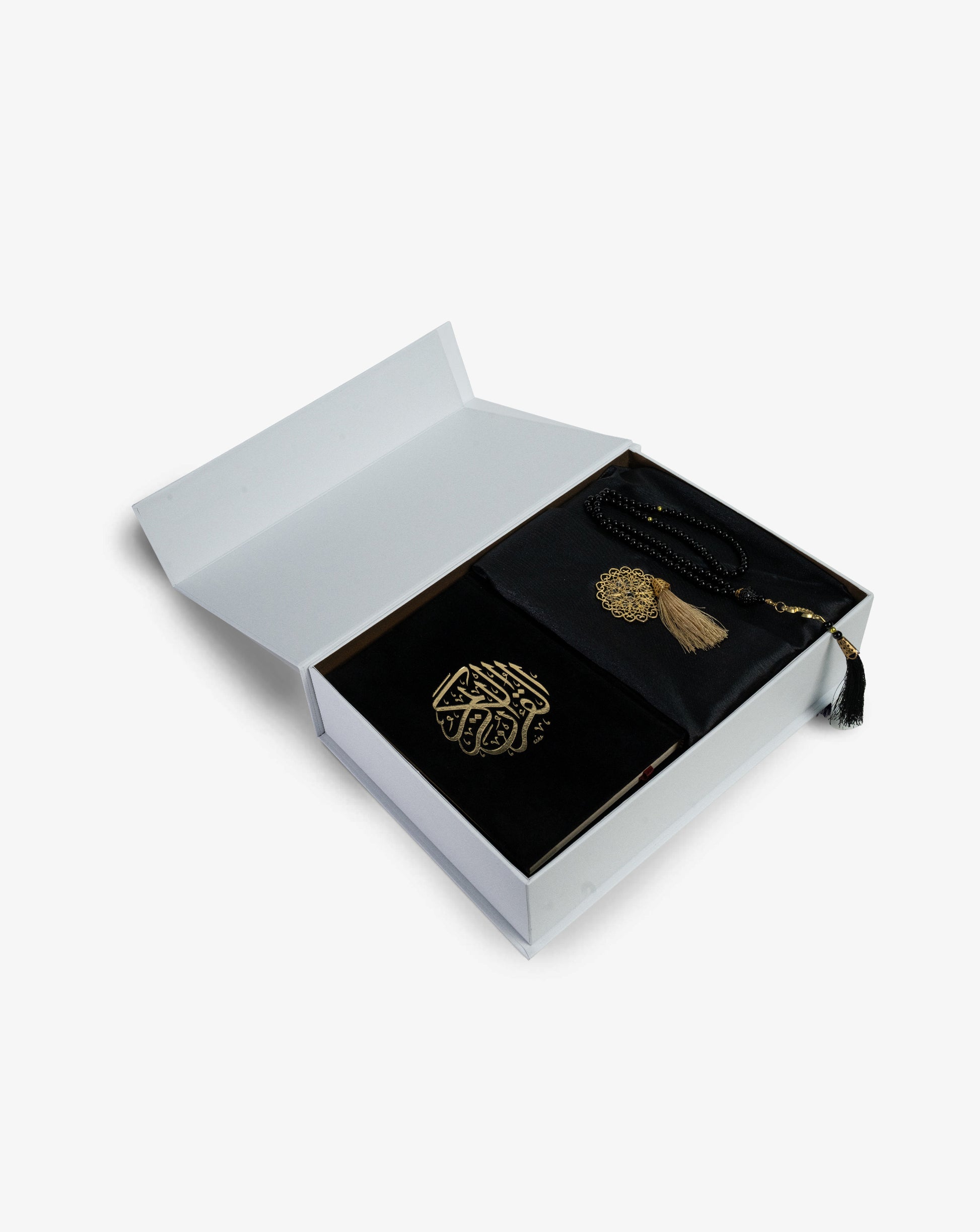 prayer kit with a prayer rug and quran 